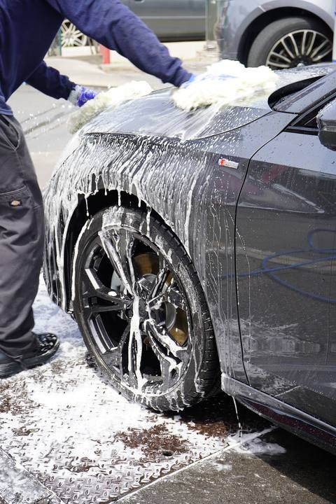 Crew member hand washing a foamed wheel