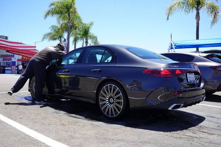 Crew member drying a grey Mercedes E-Class