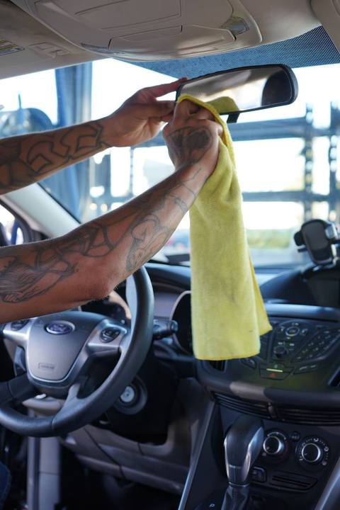 Crew member wiping down the dashboard