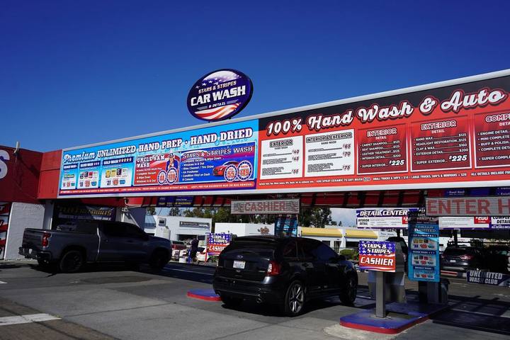 Front of Stars and Stripes Carwash with the 100 percent hand wash and auto detail sign