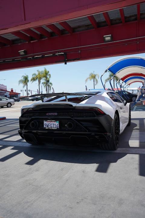 Rear of a white Lamborghini Huracan under the canopy