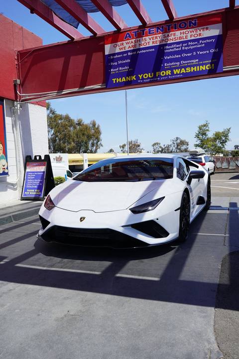 White Lamborghini Huracan under the red detail canopy