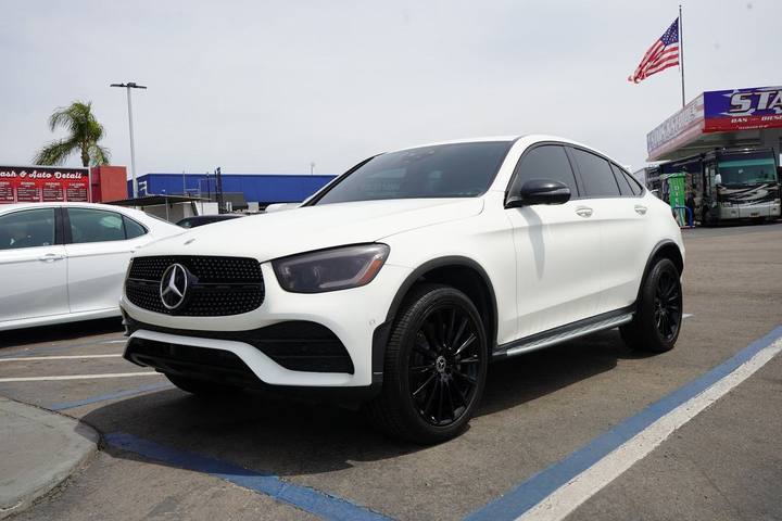White Mercedes GLC coupe on the lot with the American flag