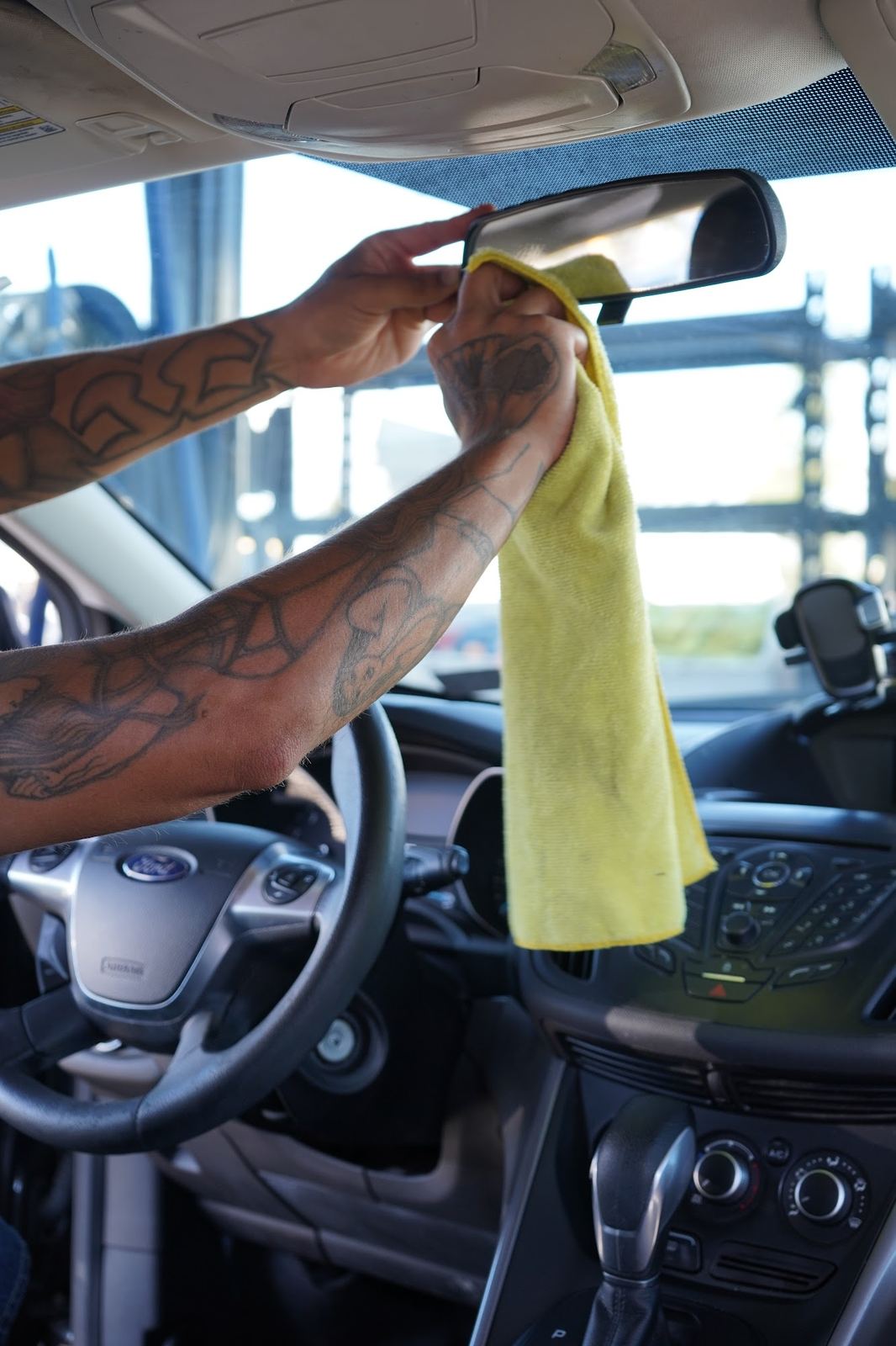 Crew member wiping down the dashboard
