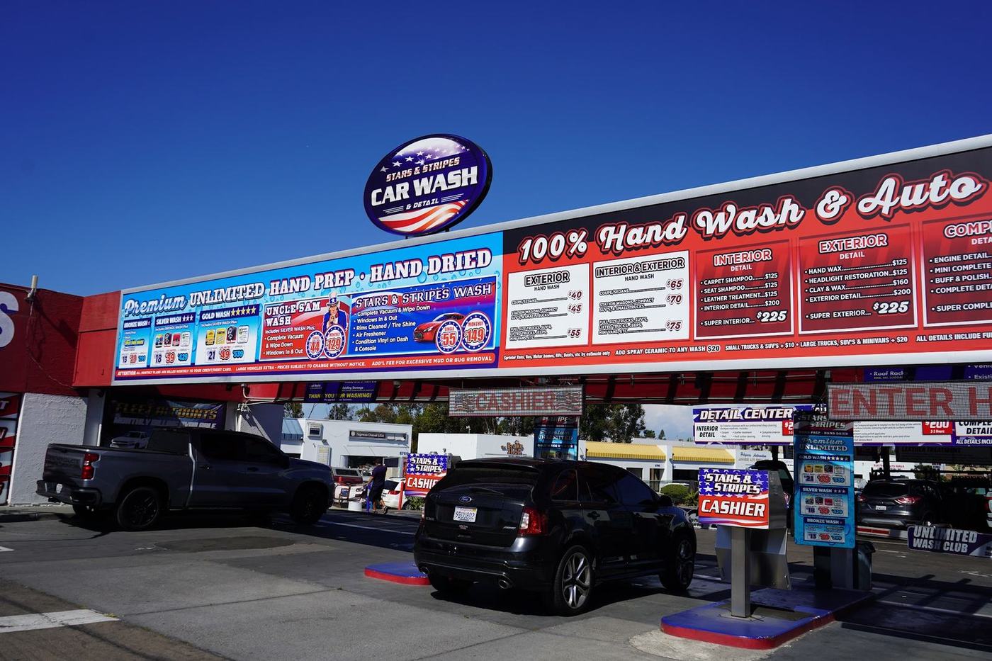 Front of Stars and Stripes Carwash with the 100 percent hand wash and auto detail sign
