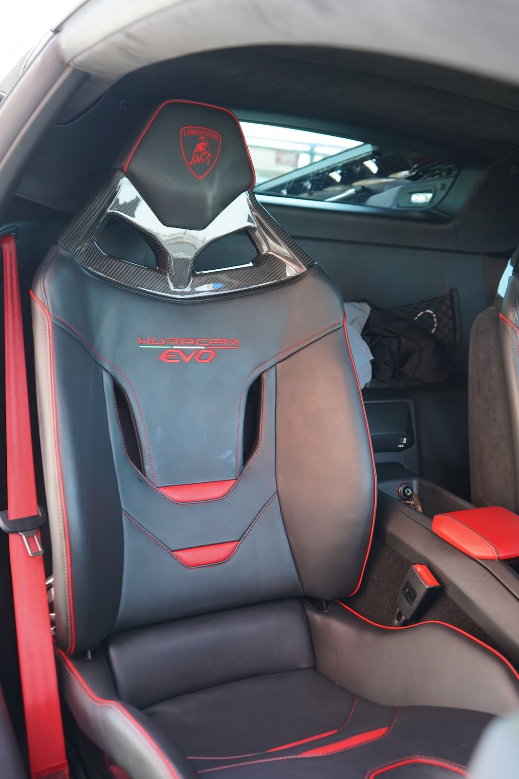Black and red Lamborghini seat after an interior detail