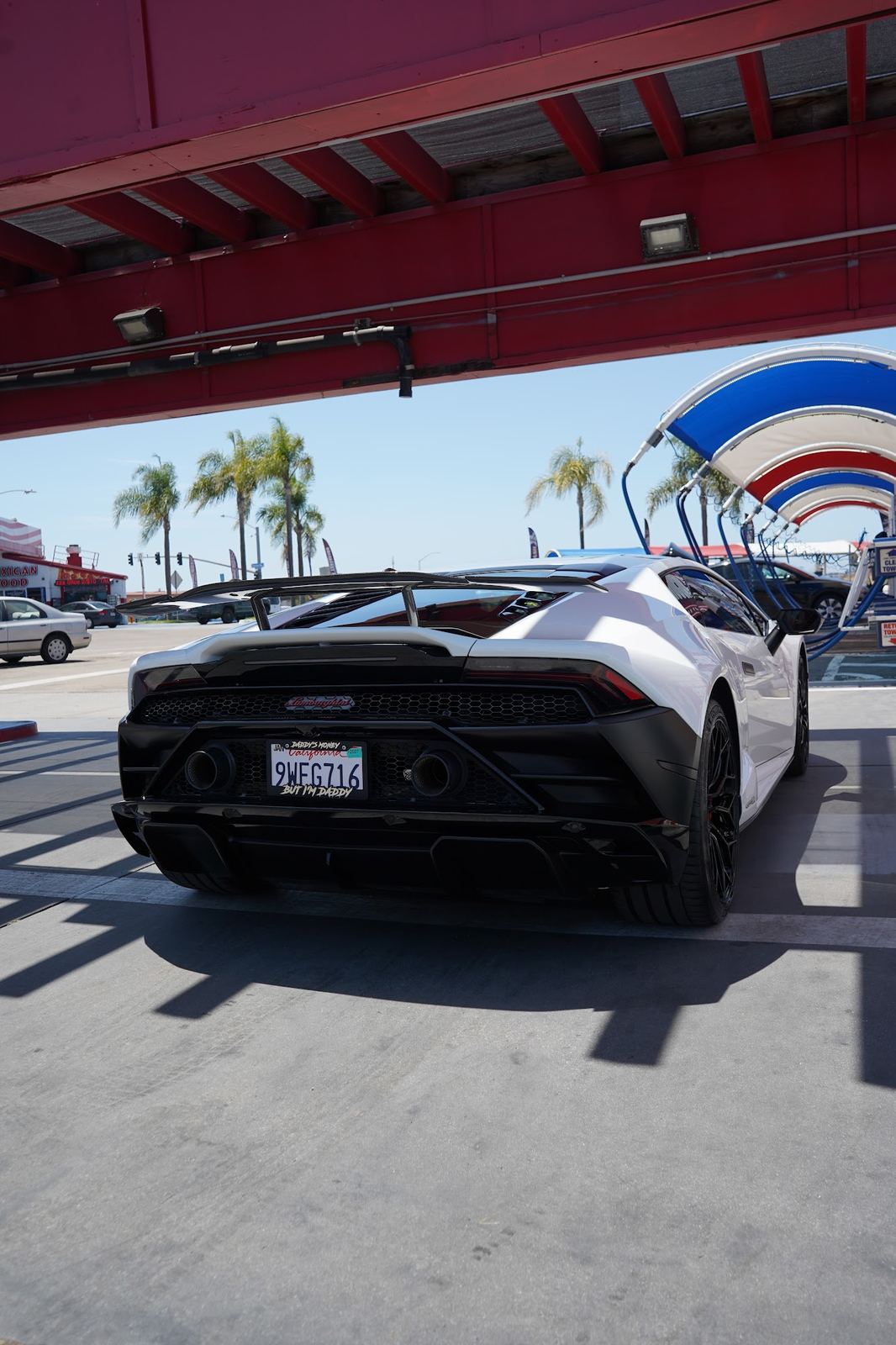 Rear of a white Lamborghini Huracan under the canopy
