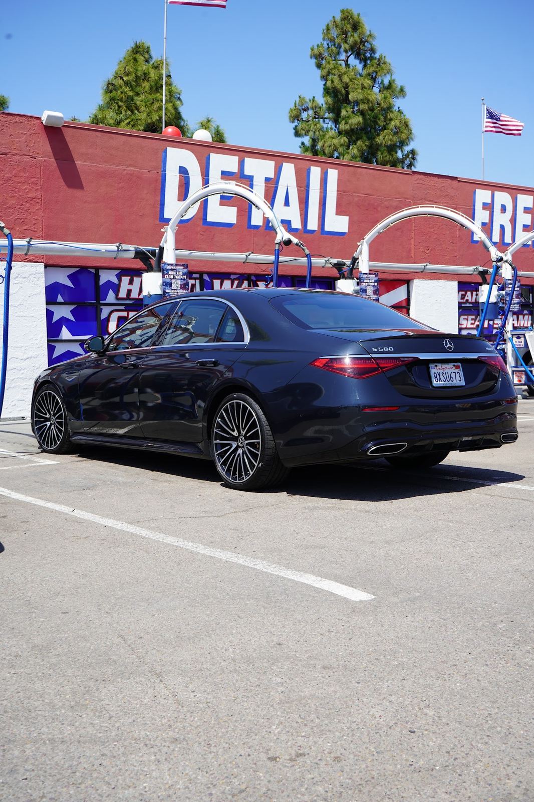 Black Mercedes S-Class in front of the Detail sign