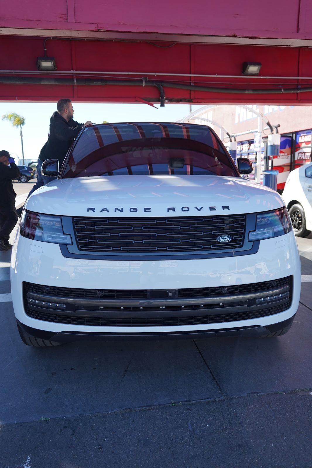White Range Rover under the red detail canopy